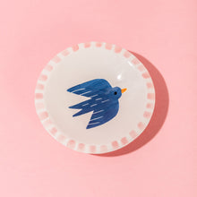 Load image into Gallery viewer, Small white plate with blue bird design on a pink background
